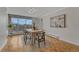 Sunlit dining area boasting a large window, neutral tones, stylish lighting, and hardwood floors at 4800 E Hale Pkwy # 802N, Denver, CO 80220