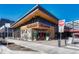 Exterior view of restaurant featuring wood and metal facade with large windows and outdoor seating at 4800 E Hale Pkwy # 802N, Denver, CO 80220