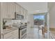 Modern kitchen with granite countertops and stainless steel appliances and balcony access at 4800 E Hale Pkwy # 802N, Denver, CO 80220