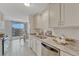 Well-lit kitchen with stainless steel appliances, granite countertops, tile floor, and balcony access at 4800 E Hale Pkwy # 802N, Denver, CO 80220