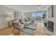 Bright living room featuring hardwood floors, a cozy fireplace, neutral decor, and a sliding glass door to a balcony at 4800 E Hale Pkwy # 802N, Denver, CO 80220