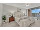 Bright main bedroom featuring balcony access, a plush bed, and minimalist decor at 4800 E Hale Pkwy # 802N, Denver, CO 80220