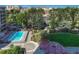 Aerial view of a well maintained community pool, landscaping, and surrounding neighborhood at 4800 E Hale Pkwy # 802N, Denver, CO 80220
