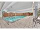 The community features a pristine indoor pool with lounge seating, brick accent wall and large windows at 4800 E Hale Pkwy # 802N, Denver, CO 80220