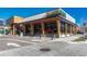 A modern restaurant exterior with an attractive design, large windows, and outdoor seating area, surrounded by clean sidewalks at 4800 E Hale Pkwy # 802N, Denver, CO 80220
