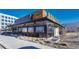 An inviting restaurant exterior showing its outdoor patio with modern design elements, appealing to potential customers at 4800 E Hale Pkwy # 802N, Denver, CO 80220