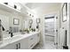 Well lit bathroom featuring double vanity, geometric floor tiles, and a separate toilet and shower room at 2635 Pierce St, Wheat Ridge, CO 80214