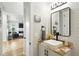 Modern bathroom with granite countertop, vessel sink, black fixtures, and a view into the living room at 2635 Pierce St, Wheat Ridge, CO 80214