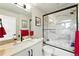 Bathroom showcasing a marble vanity, walk-in shower, and modern fixtures at 2635 Pierce St, Wheat Ridge, CO 80214