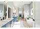 Luxurious bathroom boasting marble accents, double vanity, soaking tub, and walk-in shower at 2635 Pierce St, Wheat Ridge, CO 80214