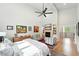 Bright bedroom featuring a vaulted ceiling, fireplace, seating area, and hardwood floors at 2635 Pierce St, Wheat Ridge, CO 80214