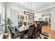 Elegant dining room with modern chandelier and views of the landscaped backyard at 2635 Pierce St, Wheat Ridge, CO 80214