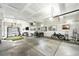Spacious garage with foosball table, bicycle, workout equipment, and art pieces hanging on the wall at 2635 Pierce St, Wheat Ridge, CO 80214