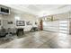 Spacious garage with foosball table, bicycle, workout equipment, and art pieces hanging on the wall at 2635 Pierce St, Wheat Ridge, CO 80214