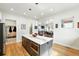 Spacious kitchen with a large island featuring marble countertops, barstool seating, and wooden floors at 2635 Pierce St, Wheat Ridge, CO 80214