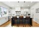 Modern kitchen with stainless steel appliances, an island with seating, and white cabinetry at 2635 Pierce St, Wheat Ridge, CO 80214