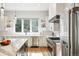 Bright, modern kitchen with stainless steel appliances, marble countertops, and a view of the backyard at 2635 Pierce St, Wheat Ridge, CO 80214