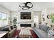 Bright living room with a modern fireplace, large TV, and comfortable seating at 2635 Pierce St, Wheat Ridge, CO 80214