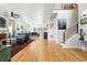 Open concept living and dining area with hardwood floors and modern staircase at 2635 Pierce St, Wheat Ridge, CO 80214