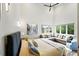Bright main bedroom with large windows, high ceilings, and a sitting area with an L-shaped couch at 2635 Pierce St, Wheat Ridge, CO 80214
