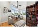 Bright home office with large windows, built-in bookcase, and comfortable seating at 2635 Pierce St, Wheat Ridge, CO 80214