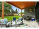 Spacious covered patio with an outdoor dining area, a seating area and a view of the lush backyard at 2635 Pierce St, Wheat Ridge, CO 80214