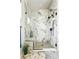 Spacious walk-in shower featuring marble tile, a rain shower head, and a built-in bench at 2635 Pierce St, Wheat Ridge, CO 80214