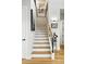 Bright staircase with wood treads and modern railings connecting the floors at 2635 Pierce St, Wheat Ridge, CO 80214