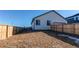 Backyard with wooden fence and small yard at 2937 Pershing St, Strasburg, CO 80136