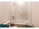 Simple bathroom with a shower/tub combo and neutral tile at 2937 Pershing St, Strasburg, CO 80136