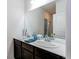 Double vanity bathroom with modern fixtures and dark brown cabinets at 2937 Pershing St, Strasburg, CO 80136