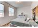 Serene bedroom with two windows, and a calming color scheme at 2937 Pershing St, Strasburg, CO 80136