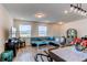 Open concept dining room with rustic table and hardwood floors at 2937 Pershing St, Strasburg, CO 80136