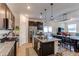 Modern kitchen with dark cabinets, granite countertops and island at 2937 Pershing St, Strasburg, CO 80136