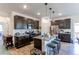 Modern kitchen with dark cabinetry, granite counters, and island at 2937 Pershing St, Strasburg, CO 80136