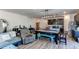 Open concept living room with hardwood floors and a teal couch at 2937 Pershing St, Strasburg, CO 80136