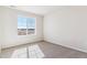 Bright bedroom with a large window showing the outside view and carpet floors at 25021 E 38Th Ave, Aurora, CO 80019