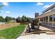 Expansive backyard deck featuring built-in grill and views of the well-manicured lawn at 7750 S Glencoe Way, Centennial, CO 80122