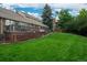 Spacious, well-maintained backyard with lush green lawn, ideal for outdoor activities and relaxation at 7750 S Glencoe Way, Centennial, CO 80122