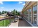 Inviting outdoor balcony with seating, a wrought iron railing, and scenic neighborhood views at 7750 S Glencoe Way, Centennial, CO 80122