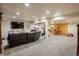 Spacious basement with a lounge area, workout area, desk, and natural lighting at 7750 S Glencoe Way, Centennial, CO 80122