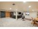 Finished basement with a lounge area, workout area, chalkboard, carpet, and recessed lighting at 7750 S Glencoe Way, Centennial, CO 80122