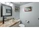 Powder room featuring modern fixtures, a glass sink, and light gray walls at 7750 S Glencoe Way, Centennial, CO 80122