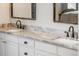 Bathroom features a dual sink vanity with marble countertops and black hardware at 7750 S Glencoe Way, Centennial, CO 80122