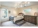 Bedroom featuring a bed, dresser, carpet, and windows for natural lighting at 7750 S Glencoe Way, Centennial, CO 80122