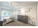 Bright bedroom with a large dresser, carpet, and a queen bed by the window at 7750 S Glencoe Way, Centennial, CO 80122