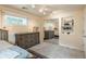 Bedroom featuring a bed, dresser, mirrored closets, built-in shelving, carpet, and natural lighting at 7750 S Glencoe Way, Centennial, CO 80122