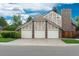Spacious home boasts a 3-car garage and well-manicured lawn enhancing the property's curb appeal at 7750 S Glencoe Way, Centennial, CO 80122