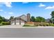 Charming home featuring three-car garage, brick chimney, and well-manicured lawn at 7750 S Glencoe Way, Centennial, CO 80122