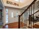 Inviting foyer showcasing hardwood floors, stained glass window, and elegant staircase, full of charm at 7750 S Glencoe Way, Centennial, CO 80122